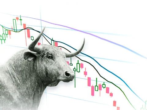 A bronze bull standing before a falling market chart